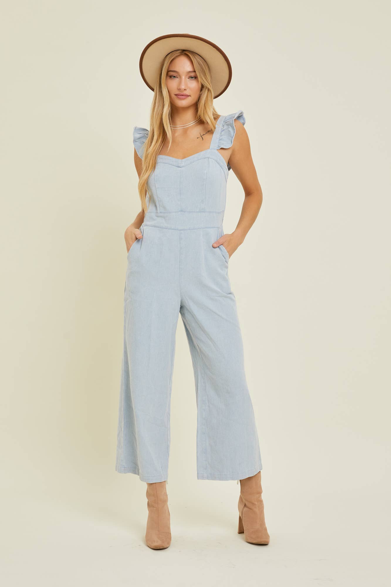 DENIM JUMPSUIT WITH RUFFLE SHOULDER STRAP IN CHAMBRAY