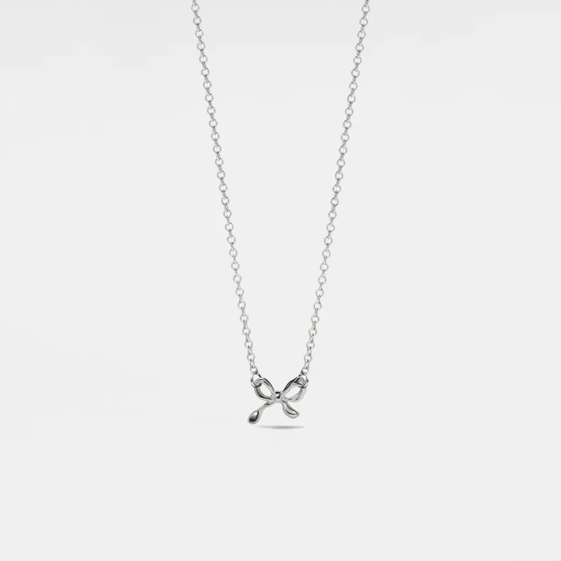 TINY SMALL BOW RIBBON NECKLACE IN GOLD-NECKLACE-MODE-Couture-Boutique-Womens-Clothing
